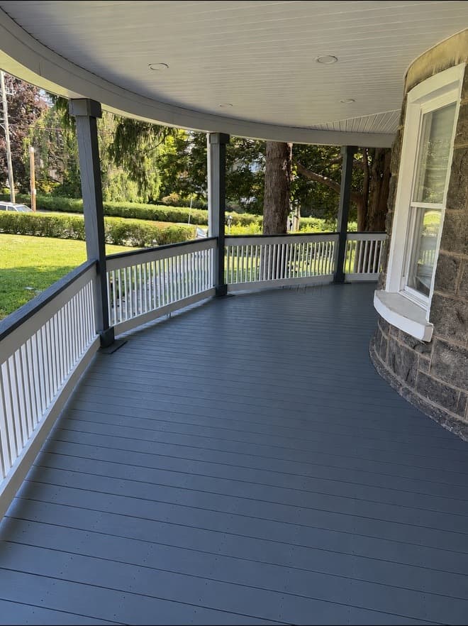 Long porch run showing the deck boards and railing detail installed by The5thwall