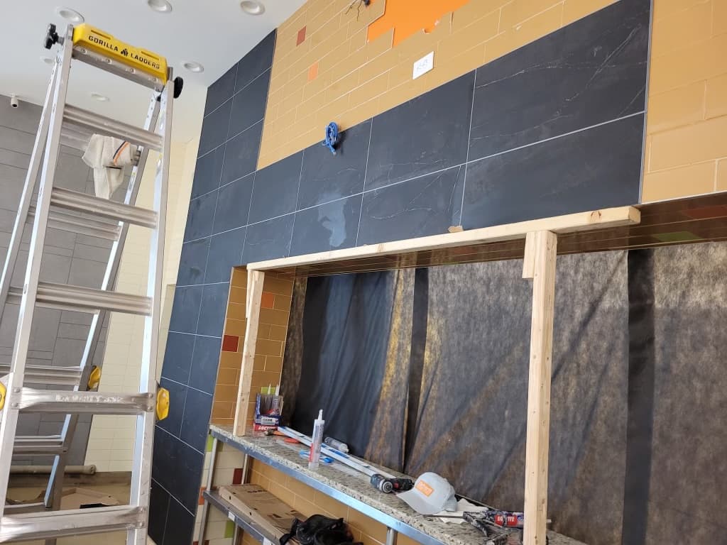 Meatheadz commercial kitchen — slate tile overlay going up